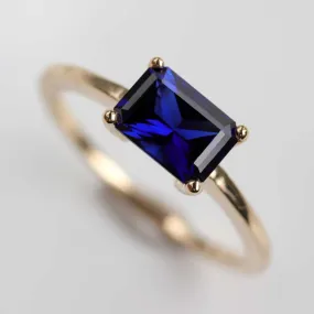 Sapphire Emerald Cut East-West Basket Solitaire