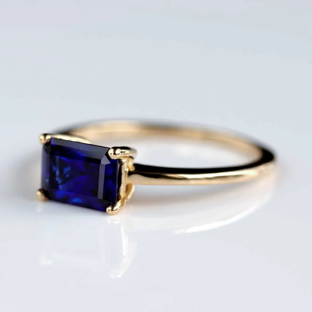 Sapphire Emerald Cut East-West Basket Solitaire